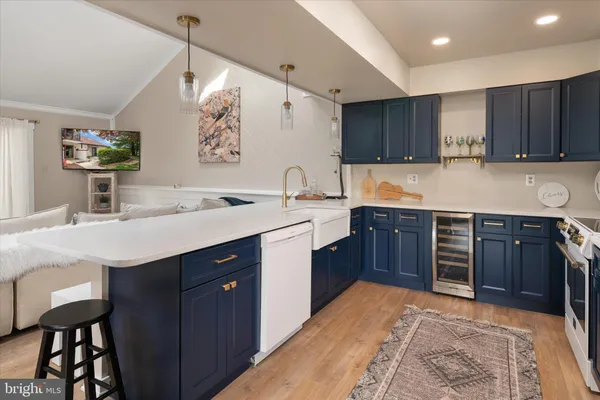 a kitchen with a sink stove and wooden cabinets