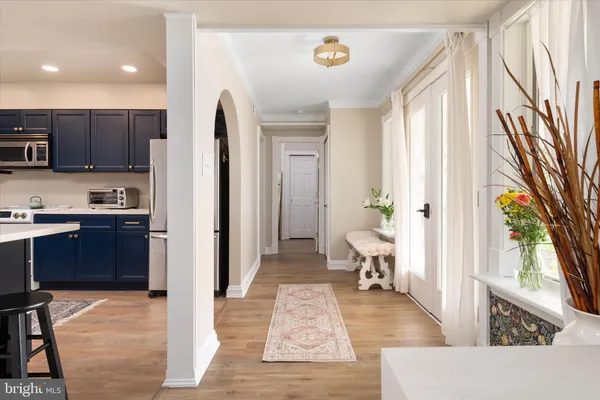 a living room with stainless steel appliances kitchen island granite countertop furniture a rug and a window