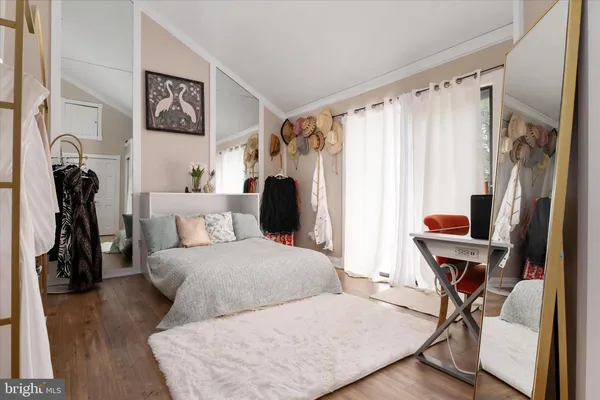 a bedroom with furniture and a window