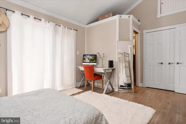 a bedroom with a bed a table and chair