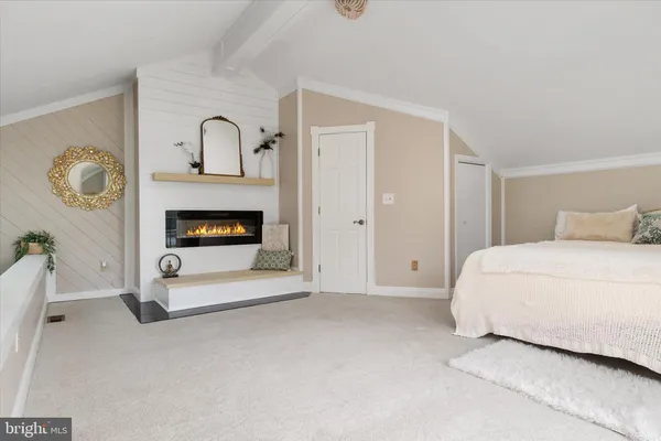 a bedroom with a bed and a fireplace