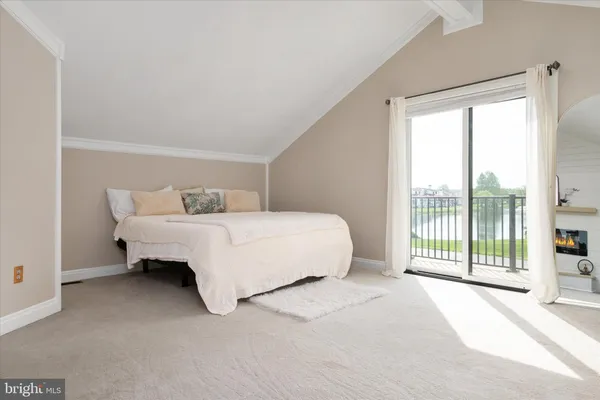 a bedroom with a bed and a large window