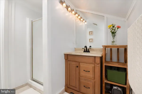 a bathroom with a sink vanity and a mirror