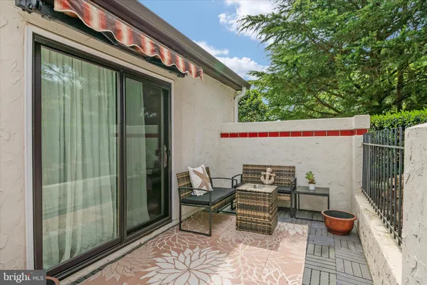 a view of a patio with table and chairs and potted plants
