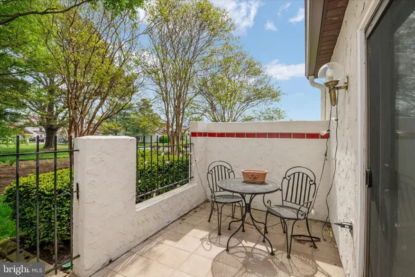 a view of a chairs and table in backyard