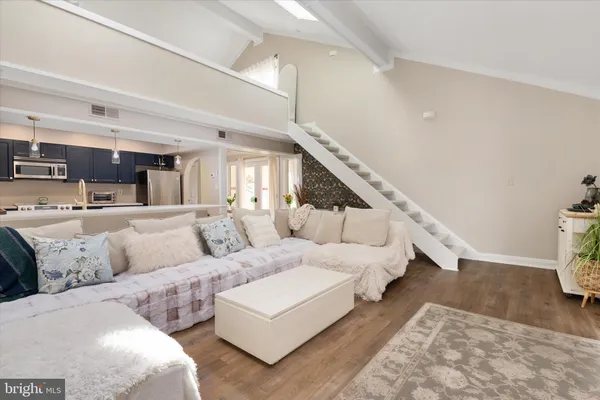 a living room with furniture and stairs