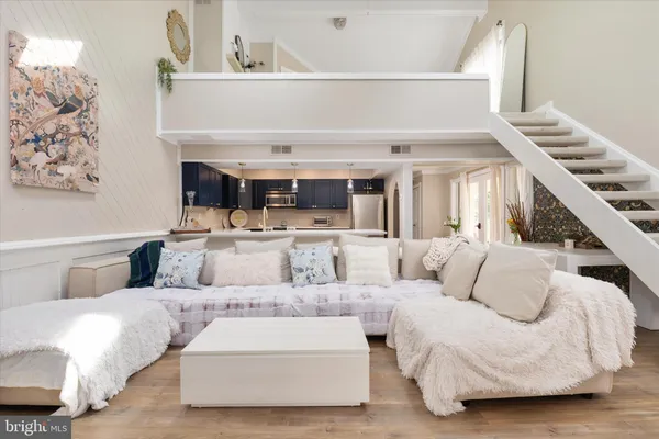 a living room with furniture and a chandelier