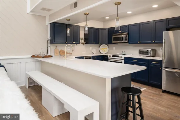 a kitchen with a sink a microwave a stove and refrigerator