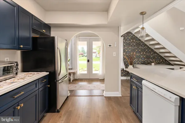 a kitchen with a refrigerator and a sink