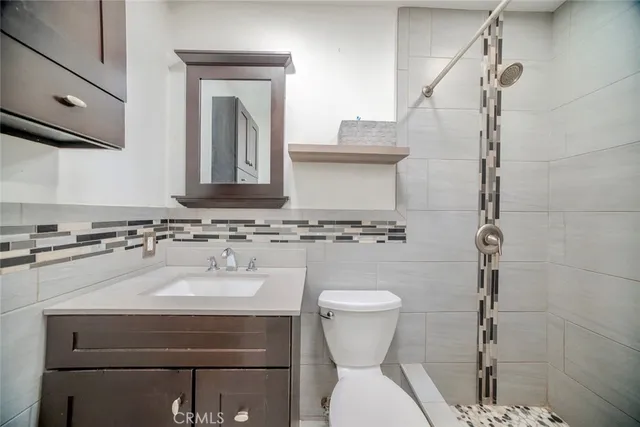 a bathroom with a sink toilet and mirror