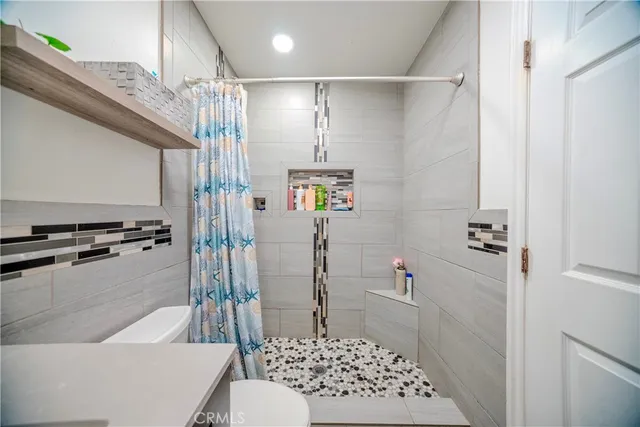 a bathroom with a shower a toilet and a shower
