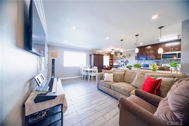 a living room with furniture and kitchen view