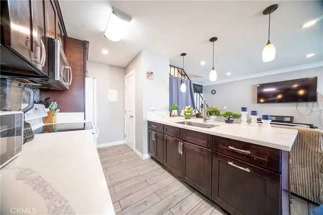 a large kitchen with stainless steel appliances kitchen island granite countertop a sink counter space and cabinets
