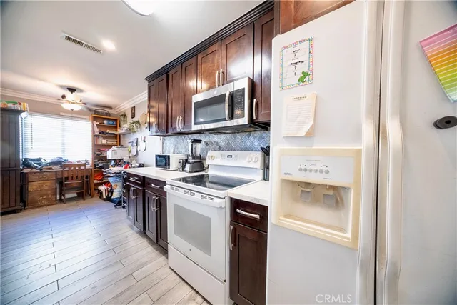 a kitchen with stainless steel appliances granite countertop a stove a sink and a refrigerator