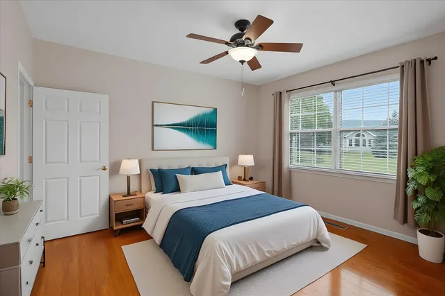 a bedroom with a large bed and a potted plant