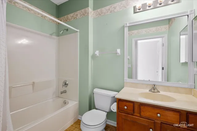 a bathroom with a sink toilet vanity and shower