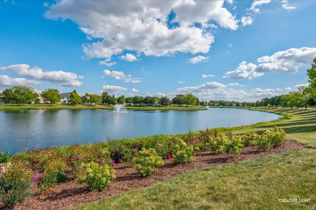 a view of a lake with houses in the back