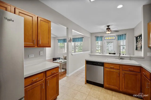 a large kitchen with stainless steel appliances granite countertop a sink and cabinets