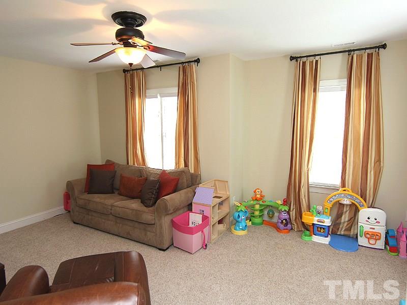 5041 Oak Park Road Raleigh, NC 27612 - Photo 14 of 19 a bedroom with furniture and a large window