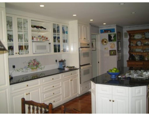 220 Ridgeway Road Weston, MA 02493 - Photo 7 of 12 a kitchen with stainless steel appliances kitchen island granite countertop a refrigerator and cabinets