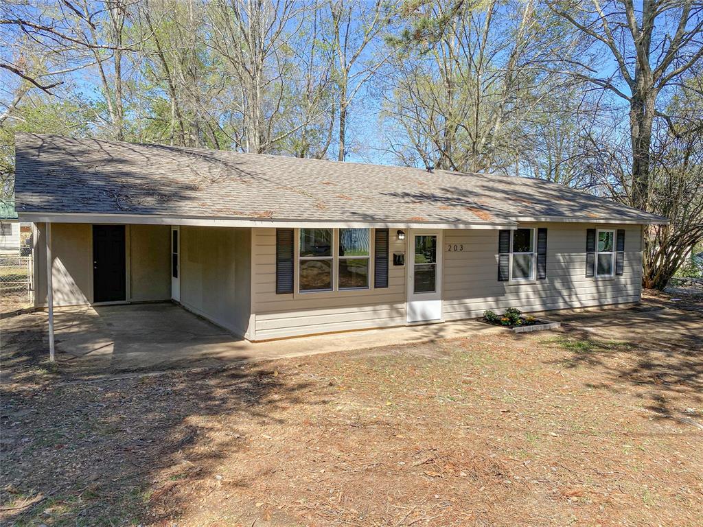203 Elam Street Mansfield, LA 71052 - Photo 2 of 18 a view of a house with a yard and large tree
