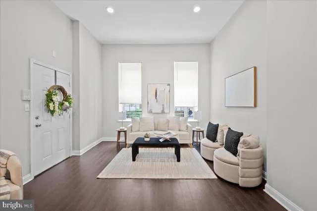 a living room with furniture rug and wooden floor
