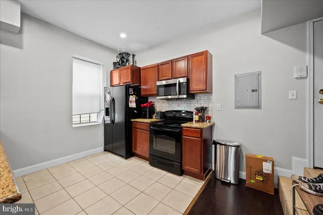 a living room with furniture a flat screen tv and a window