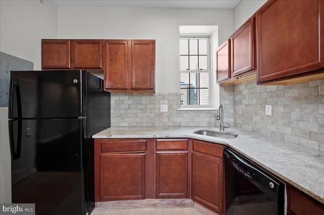 a bedroom with a large bed and a painting on the wall