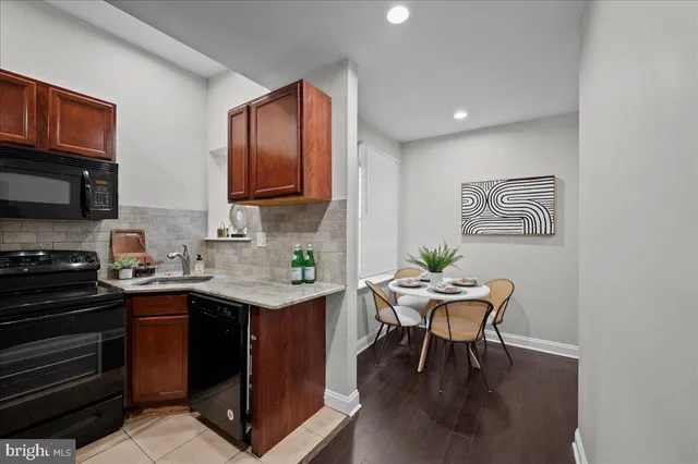 a kitchen with a cabinets appliances and a dining table