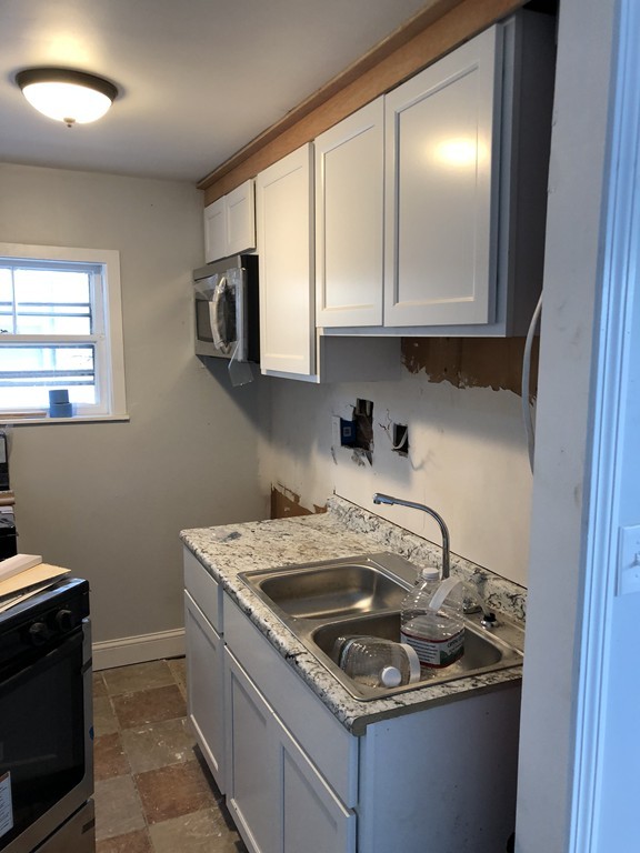 289 Warren Street Fall River, MA 02721 - Photo 1 of 11 a kitchen that has a sink and a stove