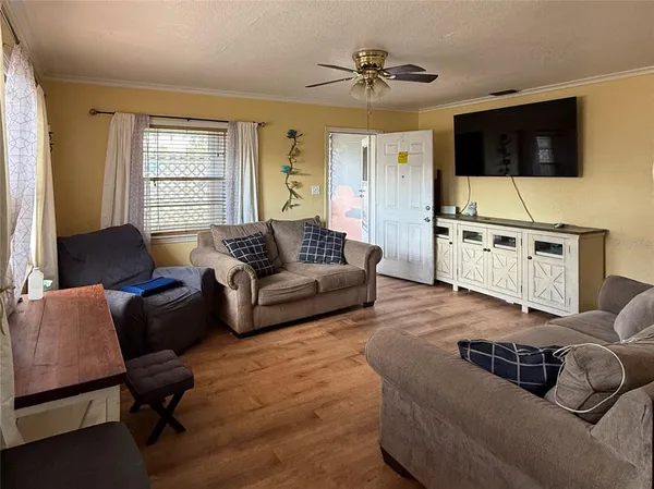 a living room with furniture and a flat screen tv