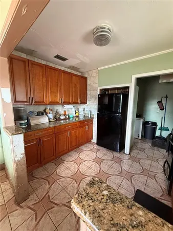 a kitchen with stainless steel appliances granite countertop a refrigerator sink and cabinets