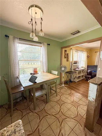 a view of a dining room with furniture window and outside view