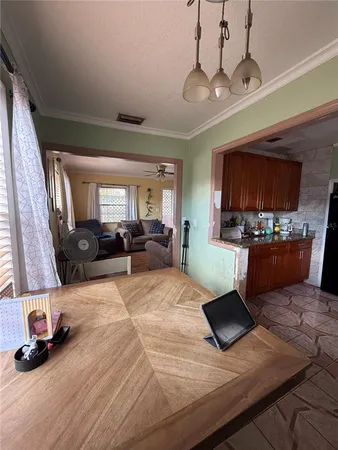 a living room with furniture and a kitchen view