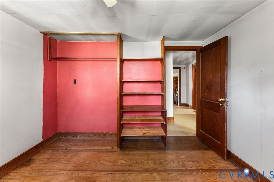19161 Hollowing Creek Road Beaverdam, VA 23015 - Photo 17 of 27 an empty room with wooden floor and white walls