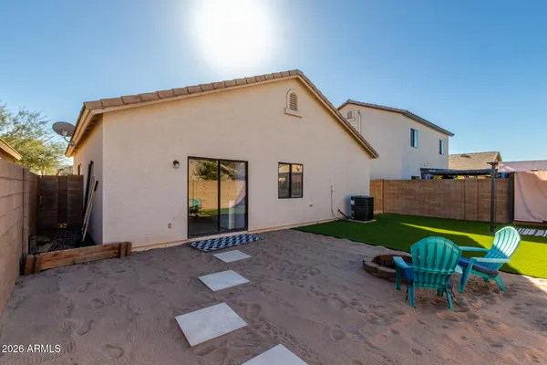 a backyard of a house with barbeque oven table and chairs