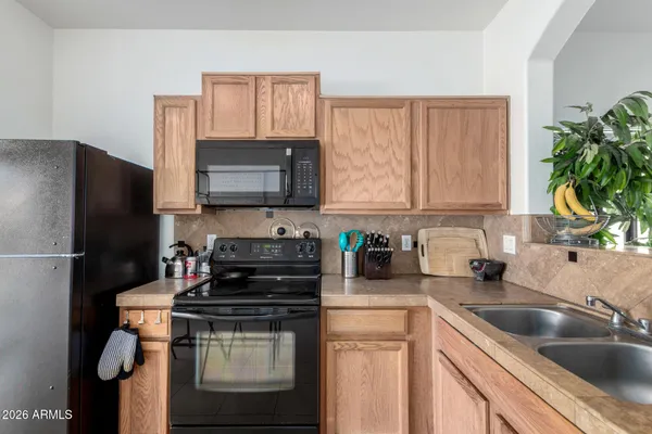 a kitchen with a sink stove and refrigerator