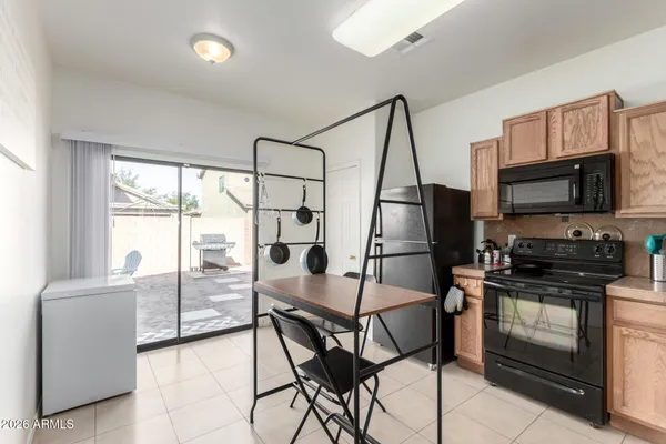 a kitchen with stainless steel appliances granite countertop a stove top oven a sink and a refrigerator