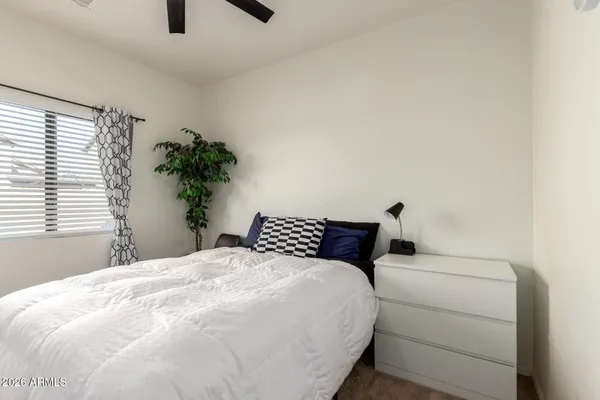 a bedroom with a bed and a potted plant