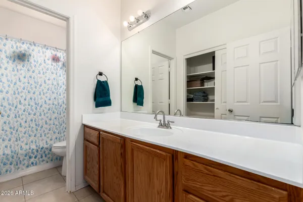a bathroom with a double vanity sink mirror and shower