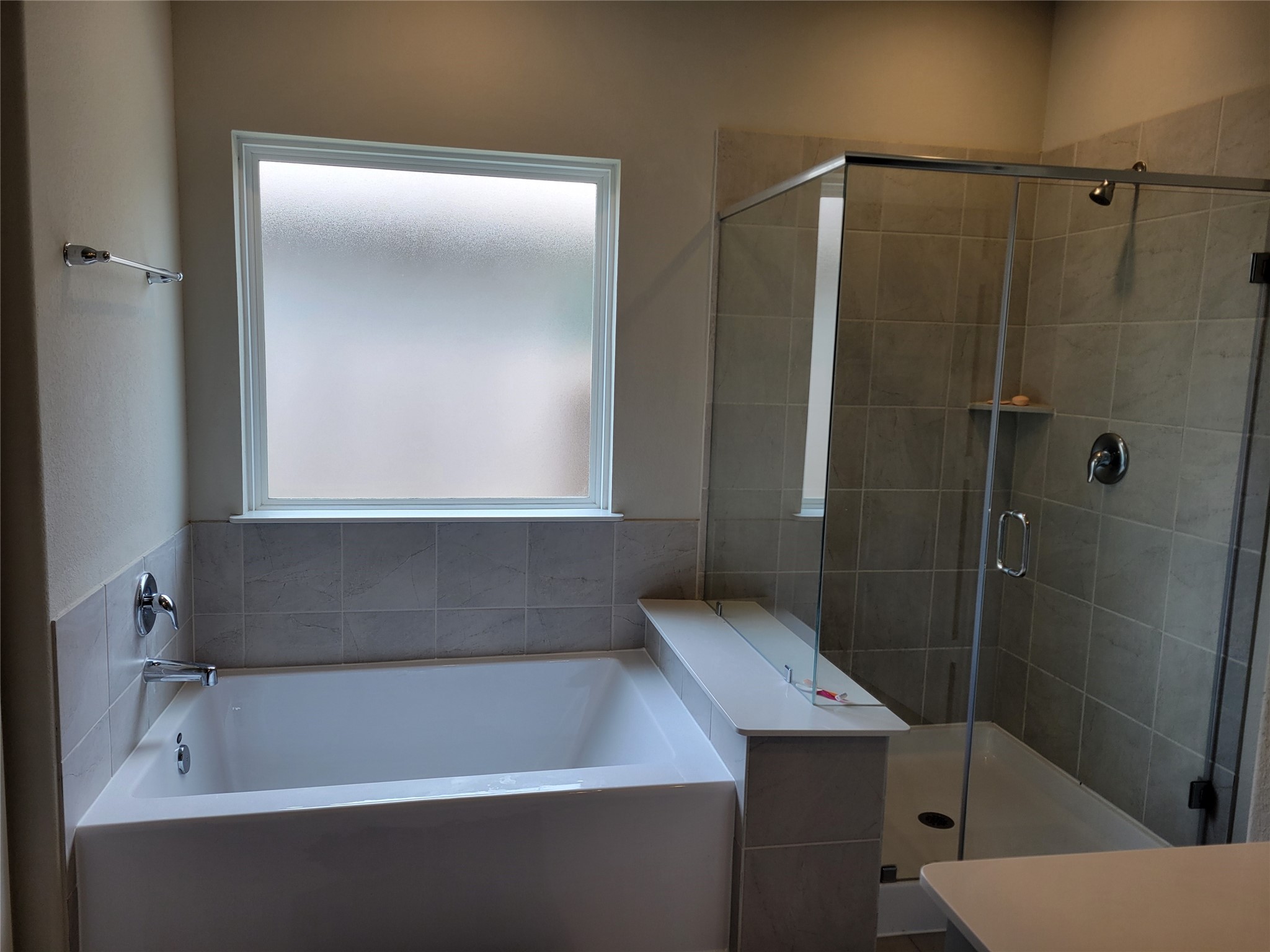 2607 Homestead Rnch Lane Crosby, TX 77532 - Photo 11 of 17 A serene retreat awaits with a soaking tub beneath a picture window and a separate shower designed for both relaxation and renewal.