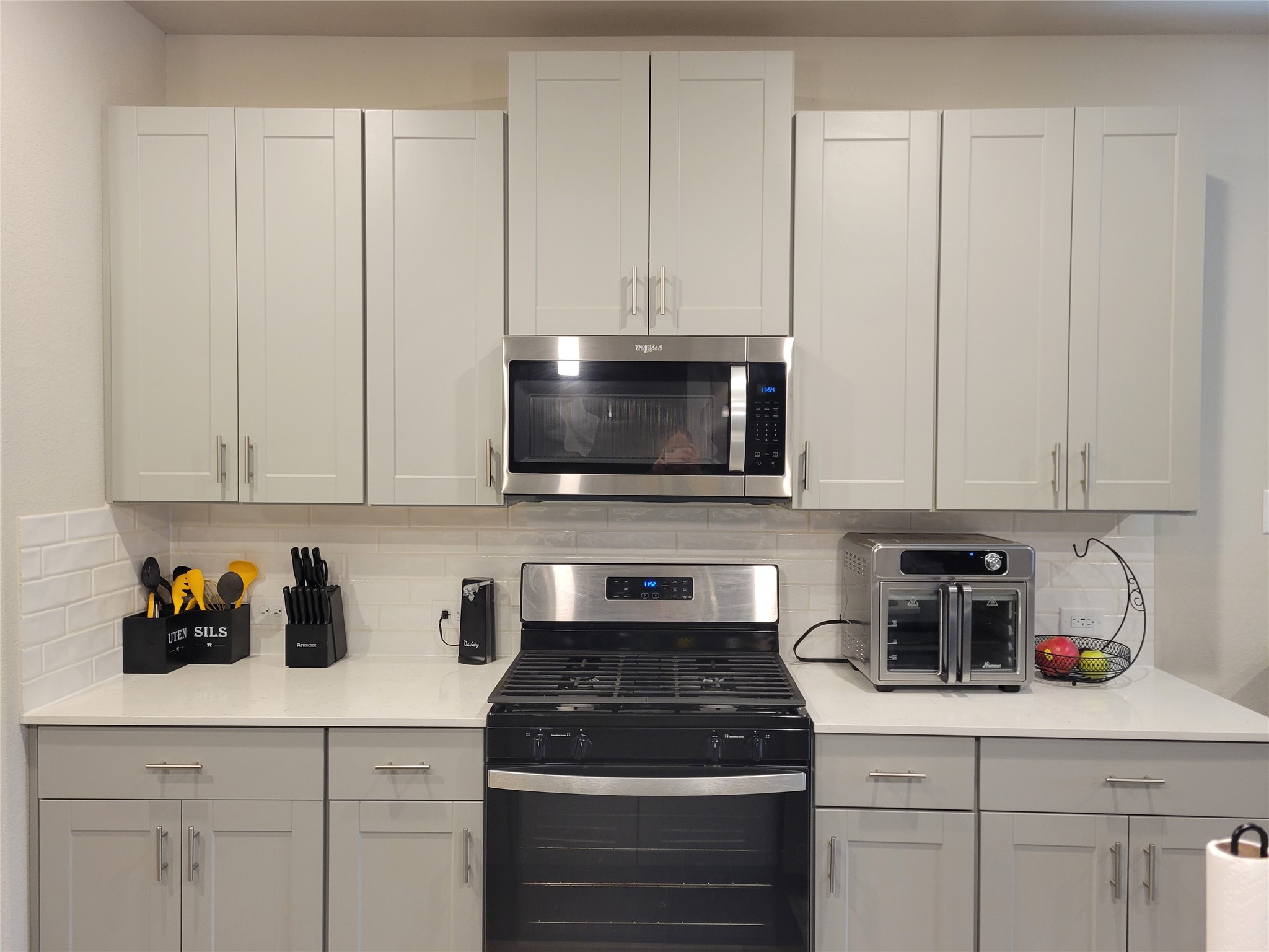 2607 Homestead Rnch Lane Crosby, TX 77532 - Photo 4 of 17 The heart of the home shines with white marble-look quartz, soft gray cabinetry, and sleek stainless and black appliances that make every meal feel inspired