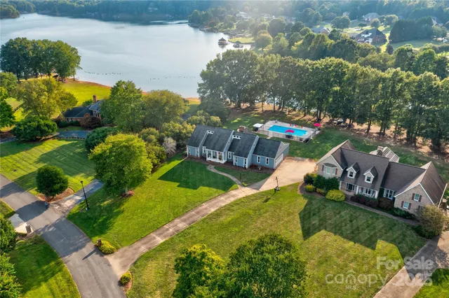 an aerial view of residential houses with outdoor space and swimming pool