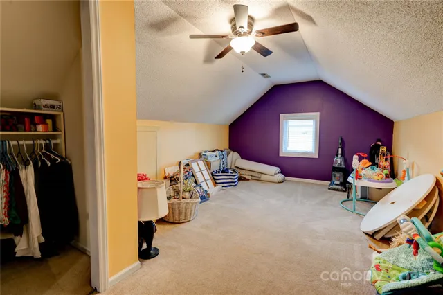 a view of a house with a backyard and a tree