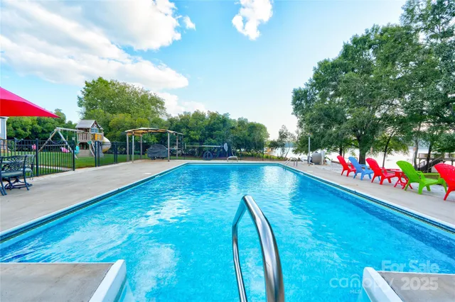a view of swimming pool with a house in the background
