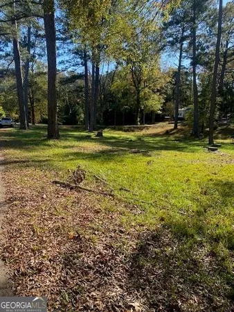 a backyard of apartments with large trees