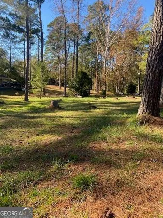 a swimming pool with outdoor seating and yard