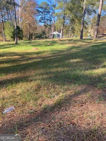 a backyard of apartments with large trees