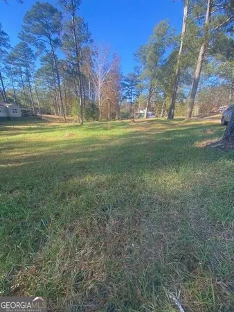 a swimming pool with outdoor seating and yard