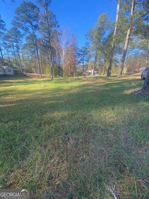 0 Woodland Court Union Point, GA 30669 - Photo 7 of 15 a backyard of apartments with large trees